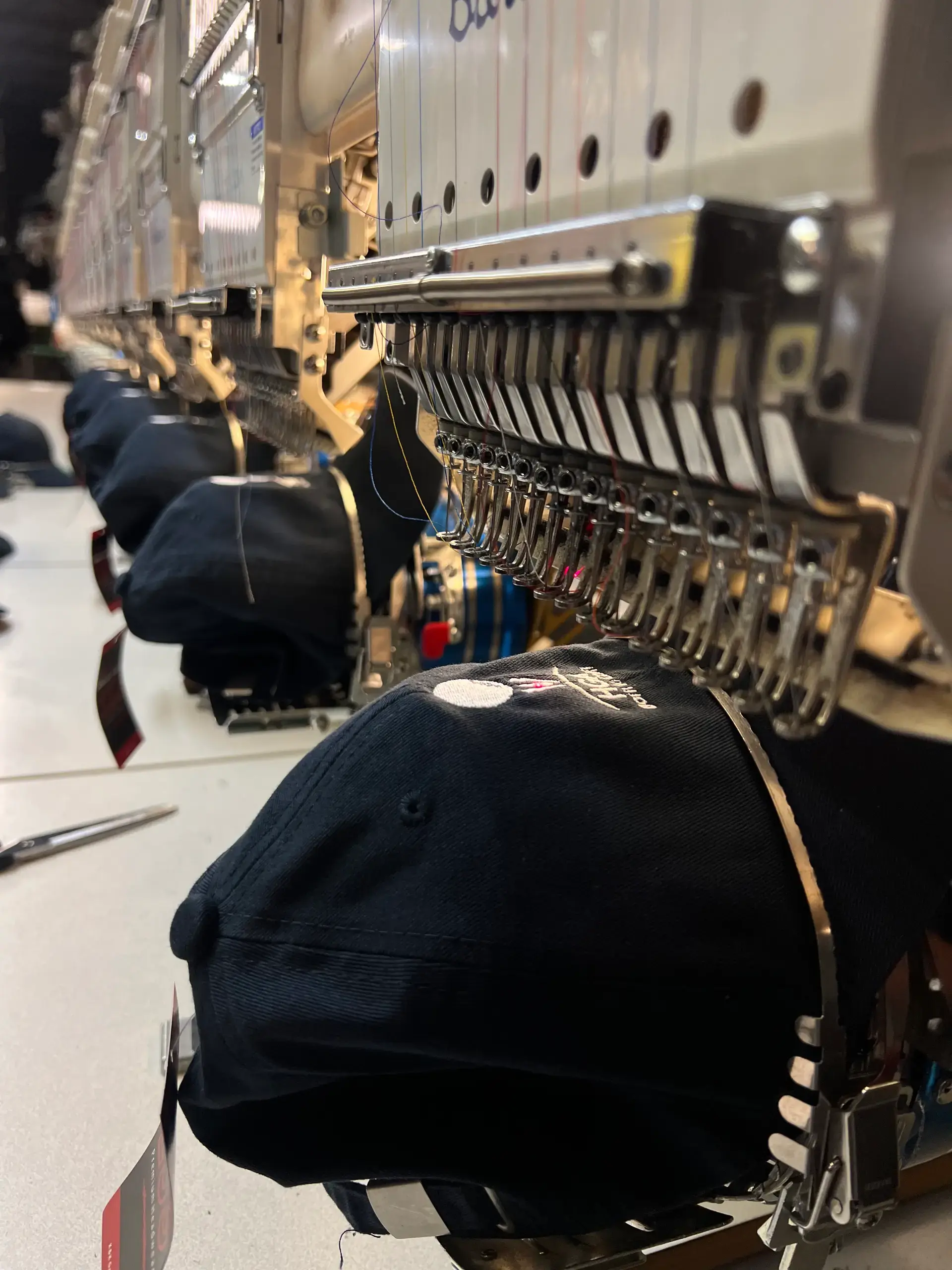 Embroidery operator working at a row of machines during an on-site setup