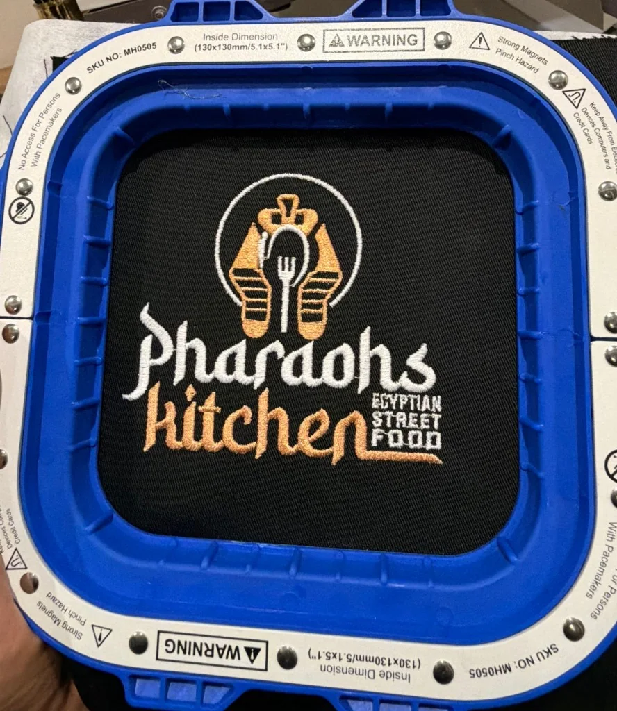 Pharaoh’s Kitchen logo embroidered in gold and white