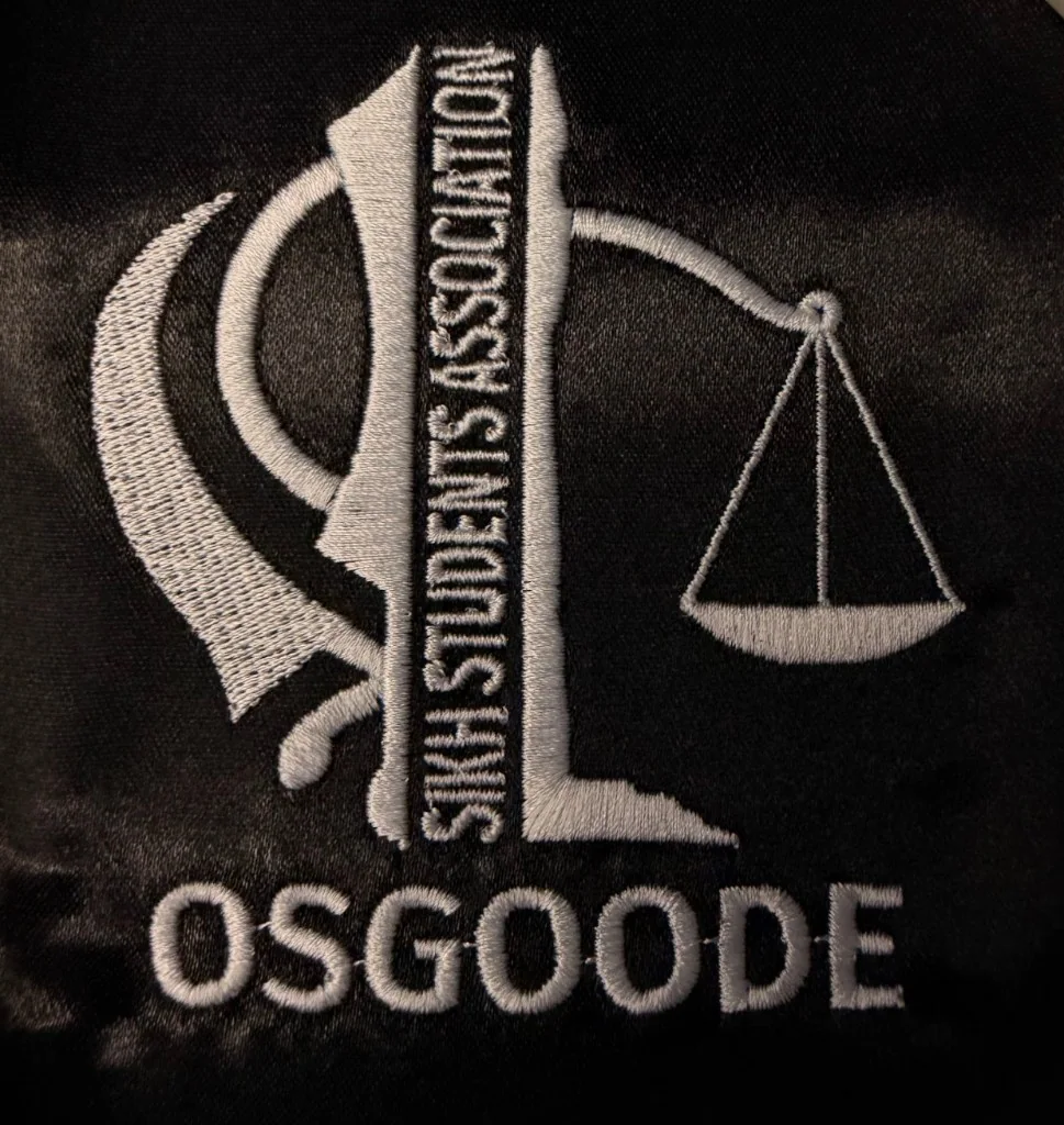 Osgoode legal association logo embroidered in white on black fabric